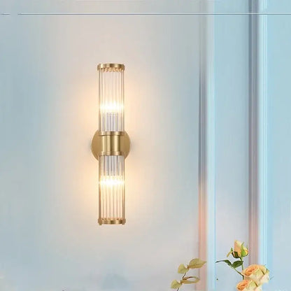 Modern crystal led gold wall sconce with vertical glass rods and warm glowing light for elegant decorbites crystal led decor