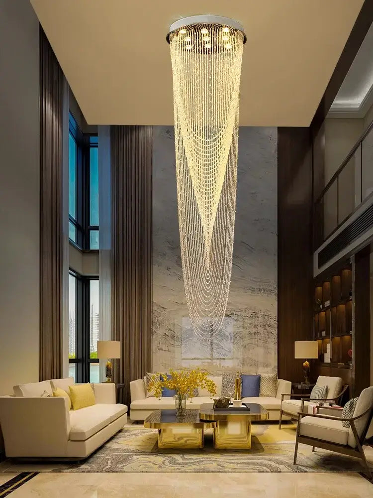 A decorbites crystal rotating chandelier with a sleek metallic frame and cascading crystal strands emitting warm light