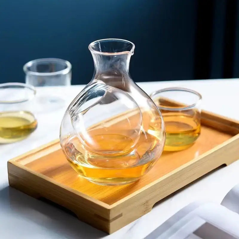 Modern crystal sake ice jug is a clear glass carafe with a bulbous body filled with amber liquid for decorbites crystal sake use