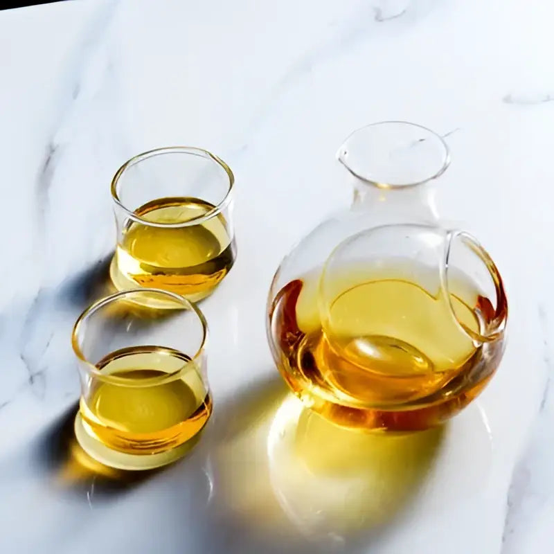 Clear glass crystal sake ice jug with rounded body and handle filled with amber liquid for dining room decorbites crystal sake