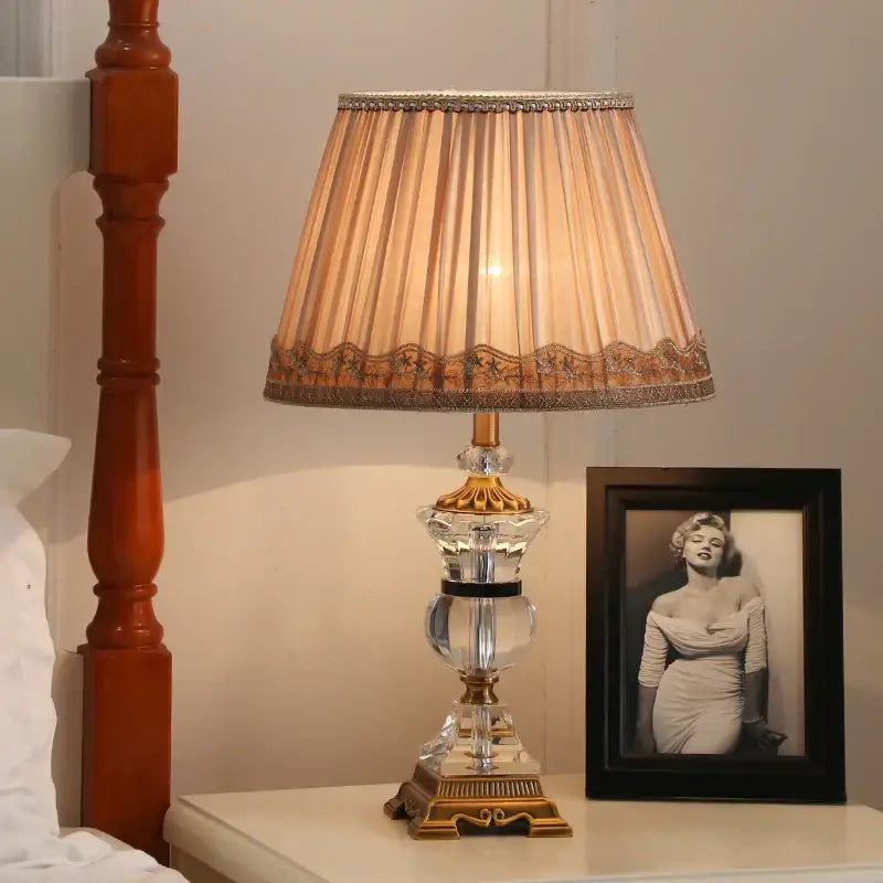 Modern crystal table lamp with brass base and beige pleated shade with gold trim for elegant decorbites crystal table decor