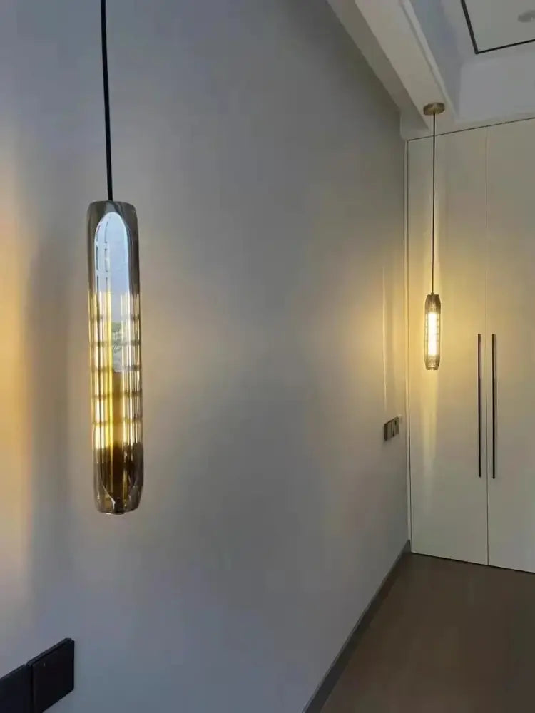 Modern crystal tulip chandelier with a sleek metallic finish and vertical ribbed design emitting warm ambient glow by decorbites crystal