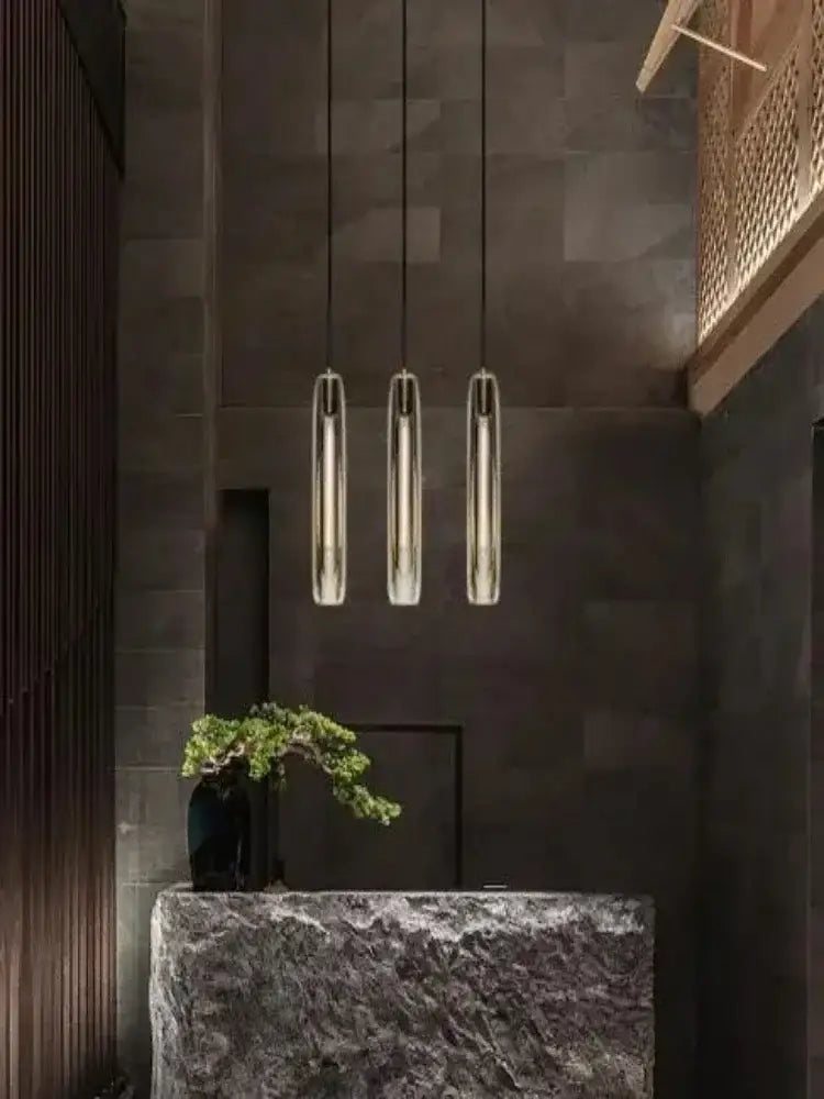 Three sleek cylindrical pendant lights with brushed metallic finish for modern crystal tulip chandelier by decorbites