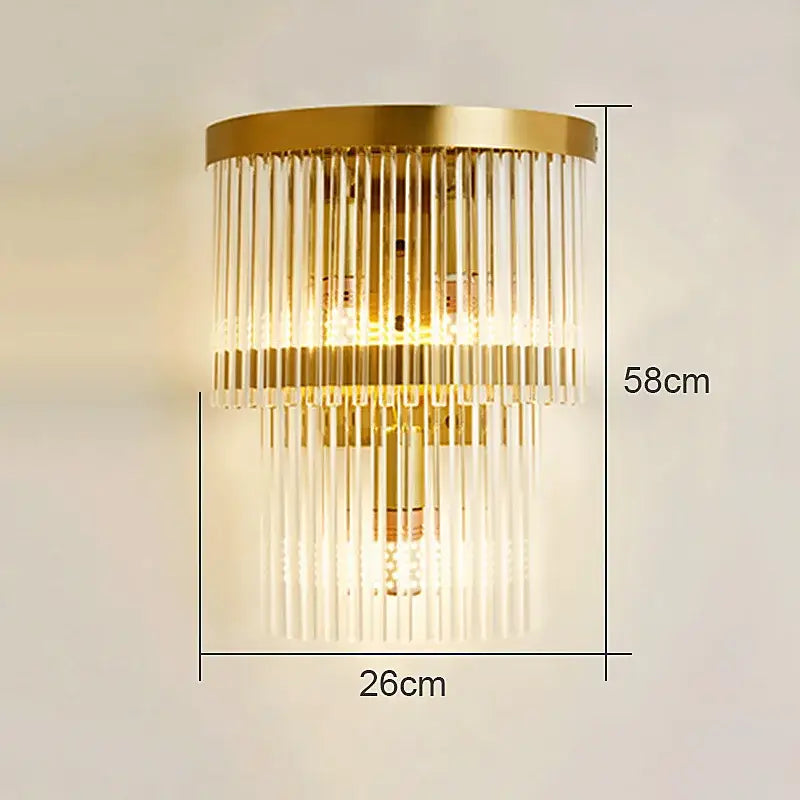 Gold-toned modern crystal wall lamp with cascading clear glass rods and circular brass base for living room decorbites crystal wall lamp