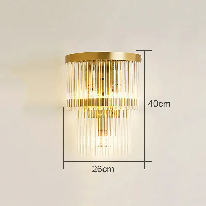 Gold-toned decorbites crystal wall lamp with cascading clear glass rods and circular brass base for living room decor