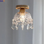 A modern decorbites crystal wood led ceiling lamp with clear teardrop crystals and a wooden base for bedroom decor
