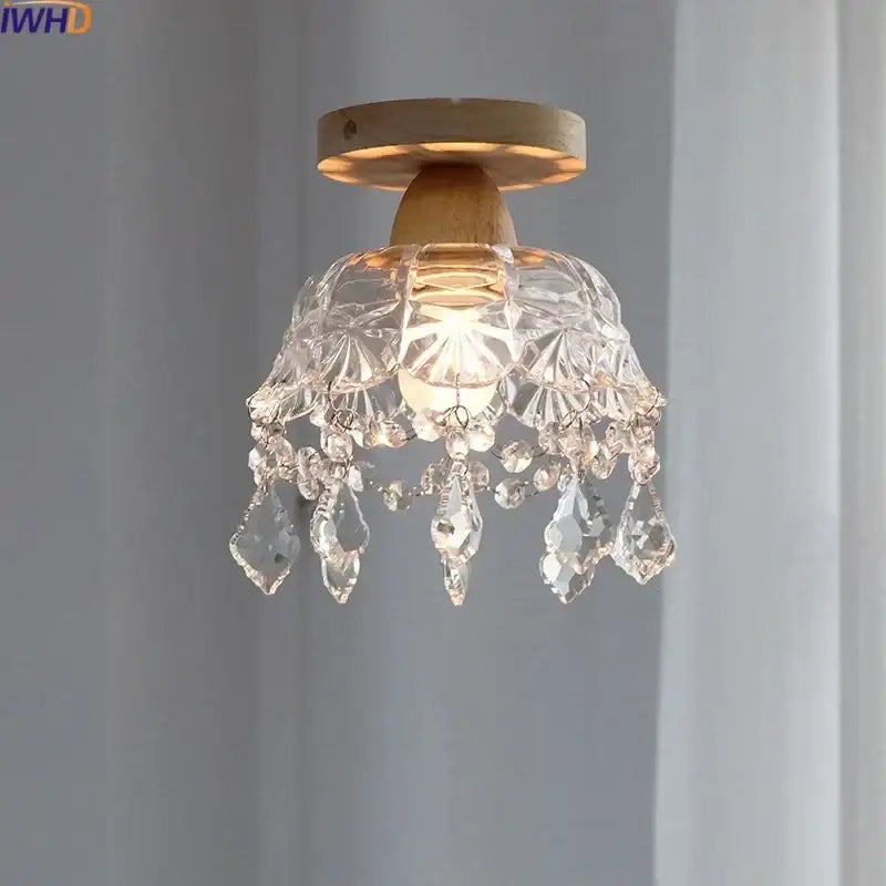 A modern decorbites crystal wood led ceiling lamp with clear teardrop crystals and a wooden base for bedroom decor