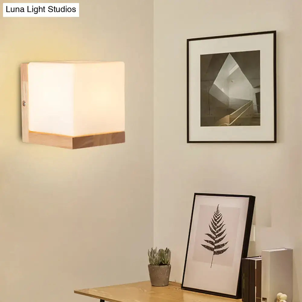 Modern cube shaped sconce wall lamp with frosted glass and wooden backplate for bedroom lighting
