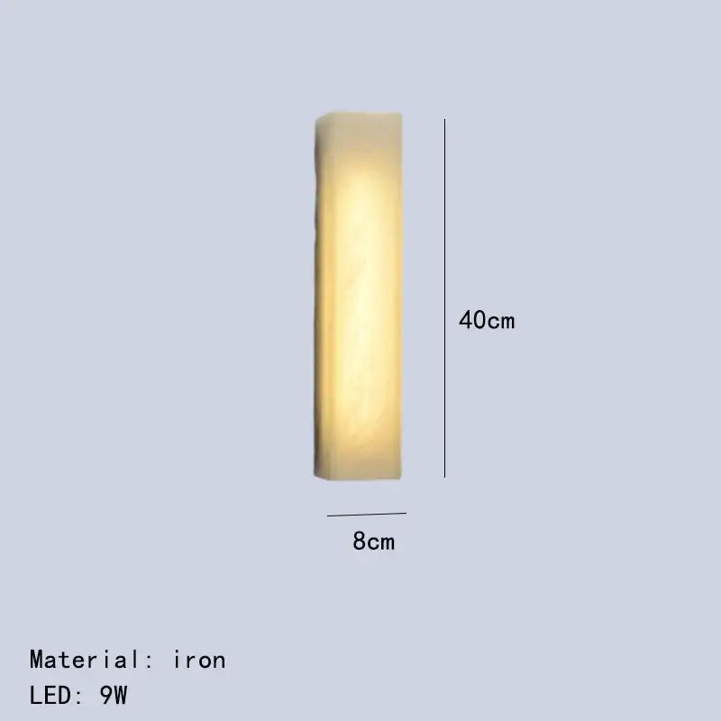 A sleek 40cm tall iron wall lamp with warm yellow glow from decorbites cuboid marble led collection for bedroom lighting