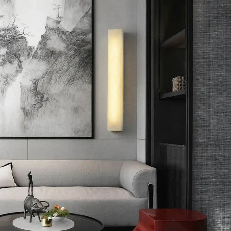 A sleek rectangular decorbites cuboid marble led wall lamp with warm glow and matte finish for bedroom lighting