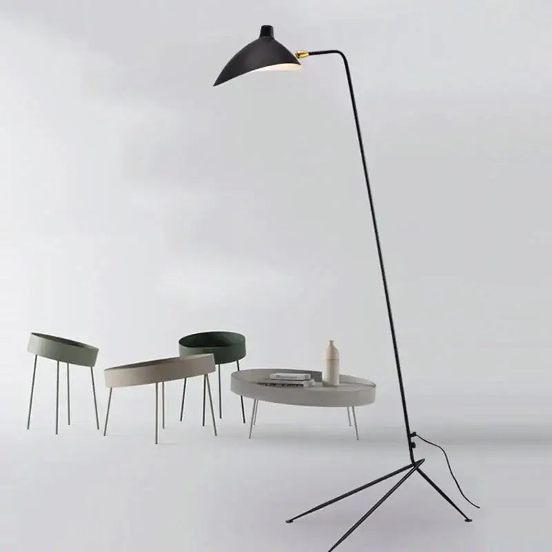 Modern curved black metal floor lamp with a sleek curved arm and conical shade for bedroom reading lighting decorbites black metal floor