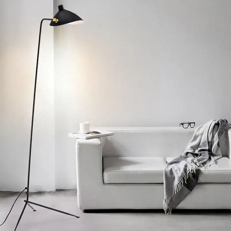Modern curved black metal floor lamp with sleek minimalist design and gold accents for bedroom reading lighting decorbites black metal floor