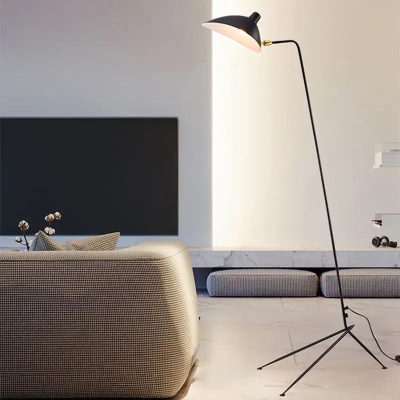Modern curved black metal floor lamp with sleek design and white interior shade for bedroom reading decorbites black metal floor