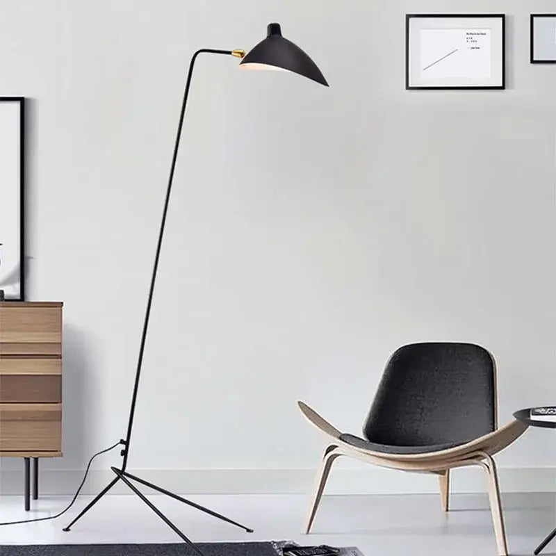 Modern curved black metal floor lamp with sleek curved neck and conical shade for bedroom reading lighting decorbites black metal floor