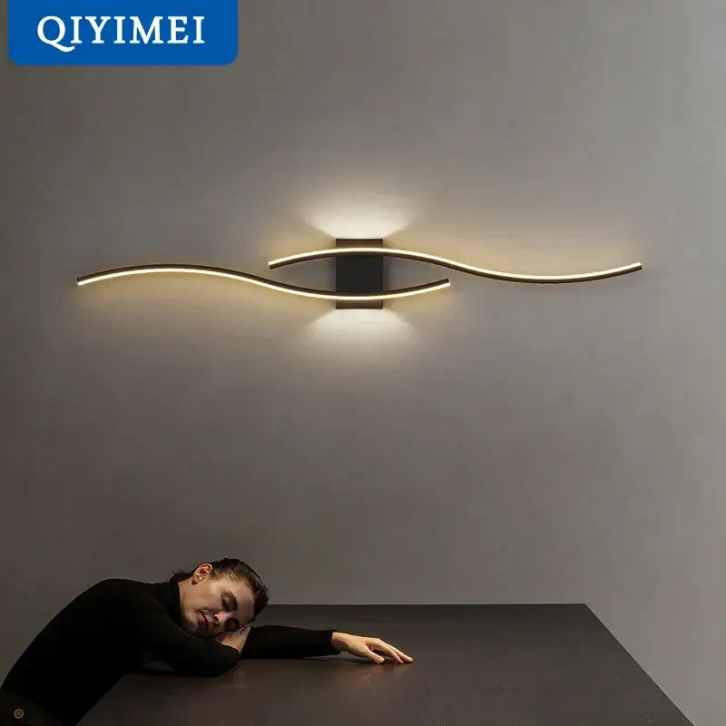 Modern curved gold led wall lamp with sleek design and black rectangular base for stylish bedroom lighting decorbites led wall