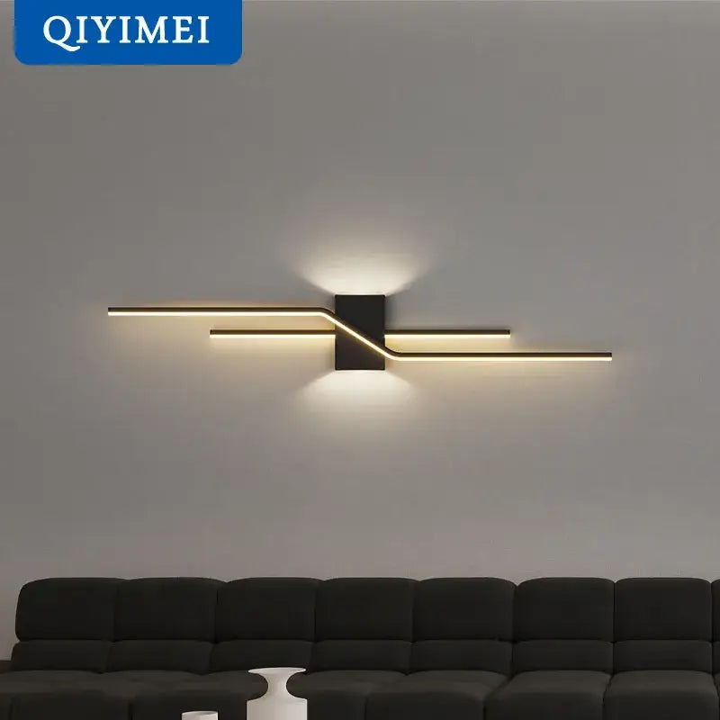Modern curved gold led wall lamp with black and gold intersecting bars emitting warm light for bedroom decorbites led wall