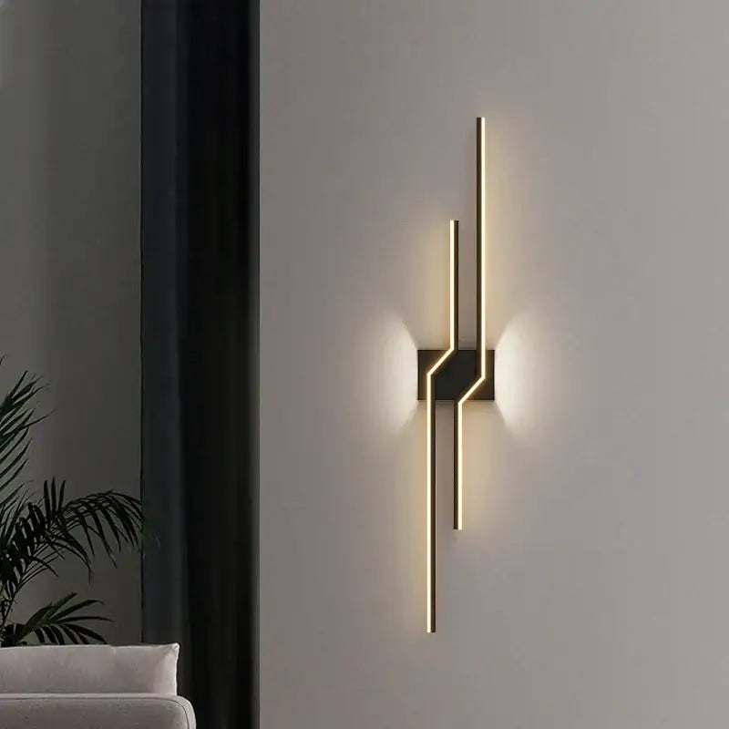 Modern curved gold led wall lamp with sleek angular design and minimalist black base for bedroom decorbites led wall lighting