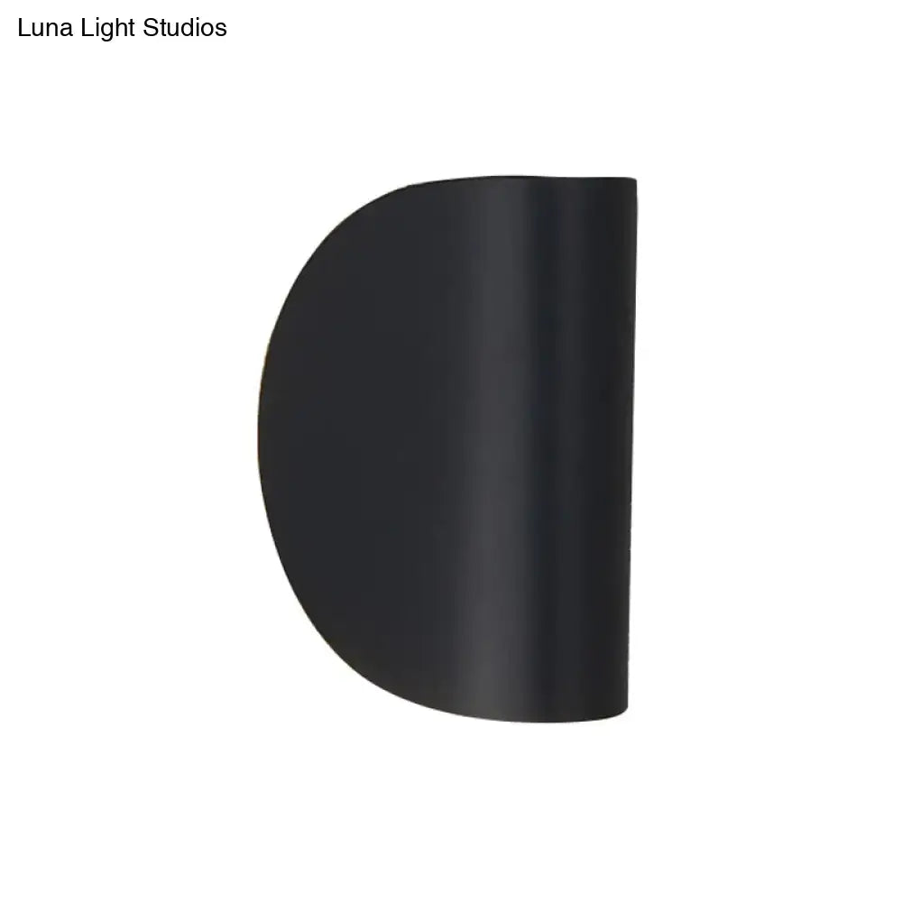 Black matte-finished semi-circular wall sconce light with modern curved design for bedroom ambient lighting