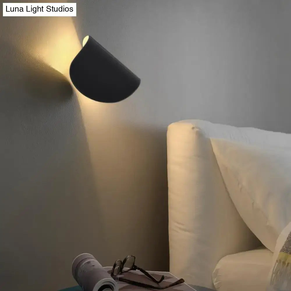 Modern black curved wall sconce light emitting warm ambient lighting ideal for bedroom wall sconce decor