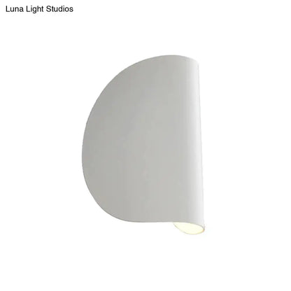 Modern curved gold wall sconce light with smooth curved design and soft diffused bedroom ambient lighting