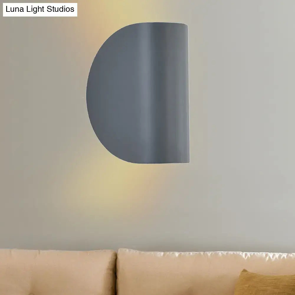 Modern curved wall sconce light in matte gray with minimalist design for bedroom ambient lighting