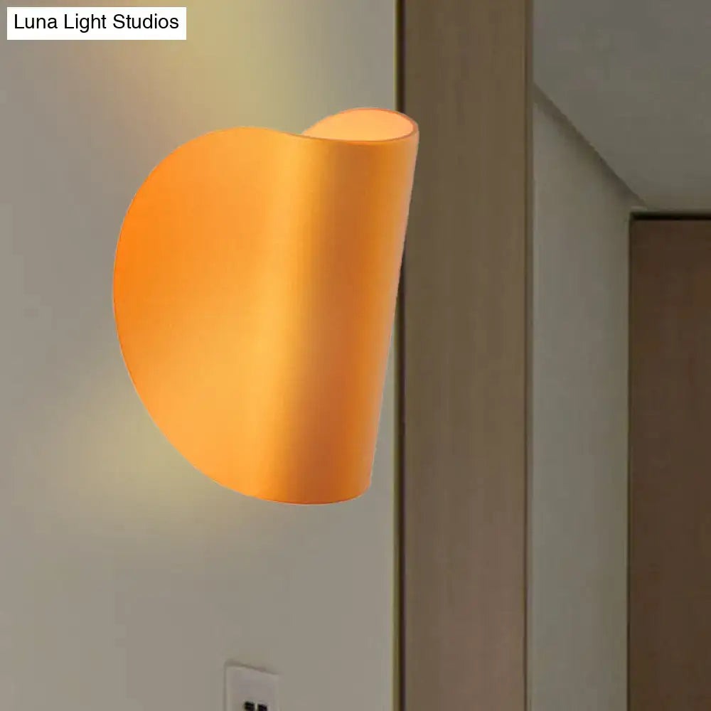 Modern curved gold wall sconce light with warm orange matte finish for bedroom ambient lighting wall sconce