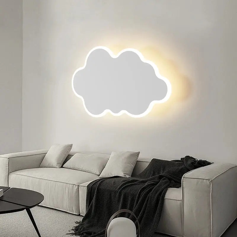 A glowing white cloud-shaped modern curved led wall sconce providing warm bedroom lighting from decorbites led wall collection