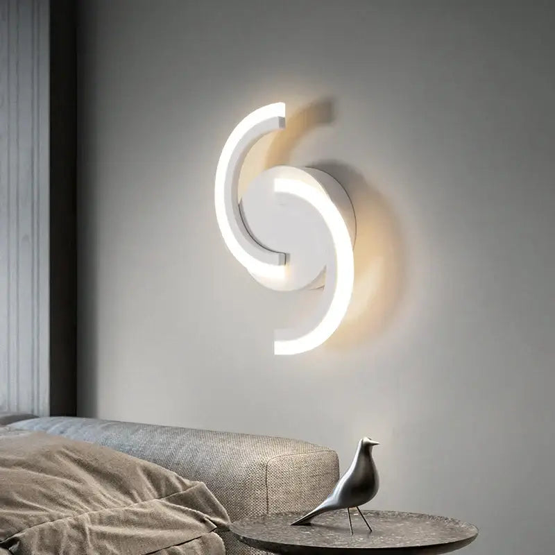 Modern curved white led wall sconces with a sleek swirling design for bedroom lighting by decorbites led wall sconces