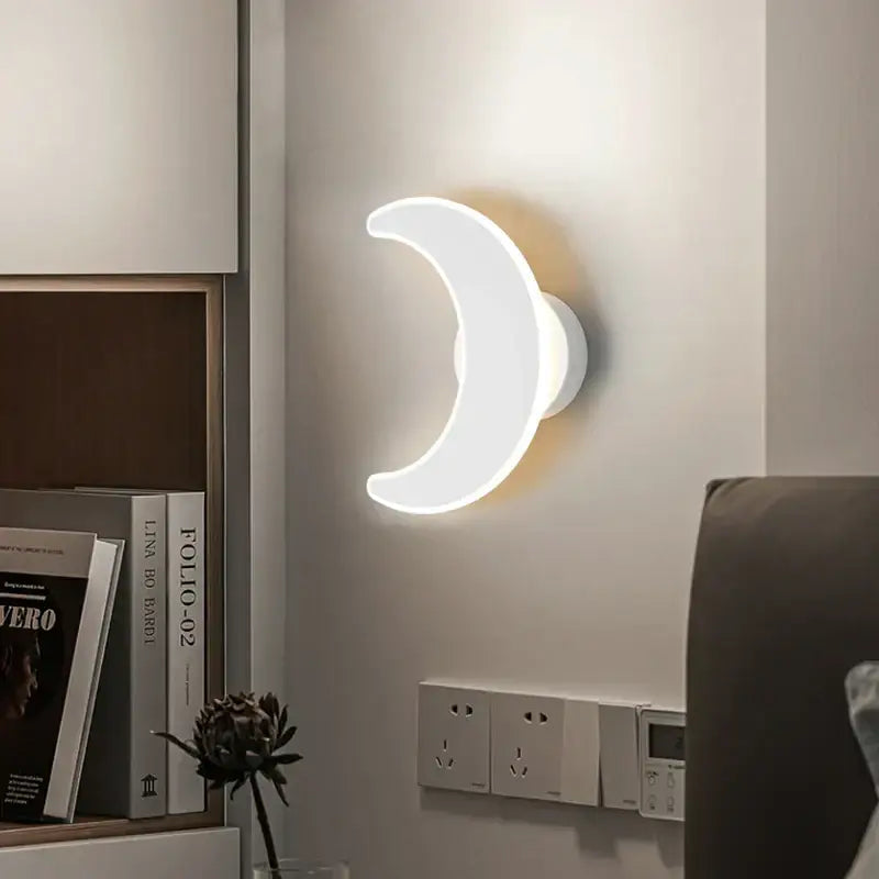 A sleek white crescent moon-shaped modern curved led wall sconce for bedroom lighting by decorbites led wall sconces