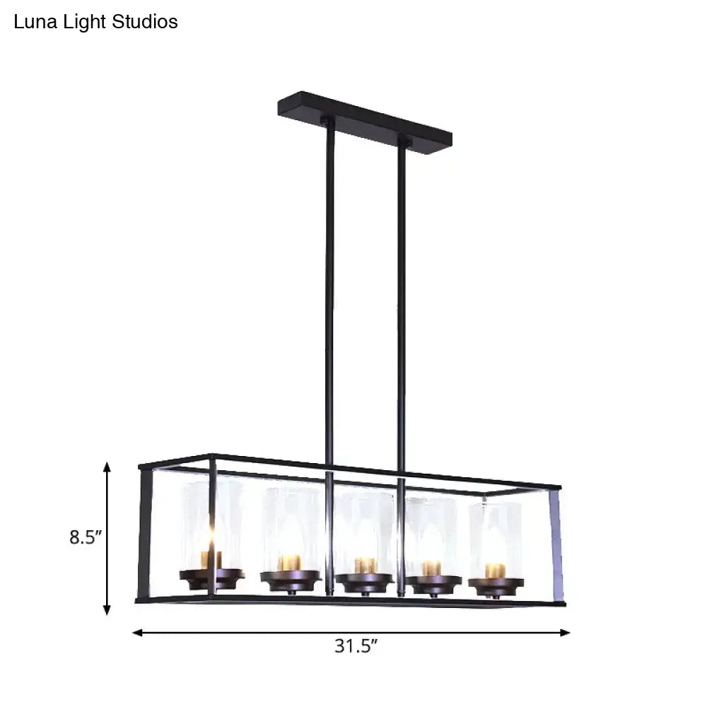 Black metal rectangular chandelier with five clear glass shade candle holders and warm-toned bulbs for dining room lighting