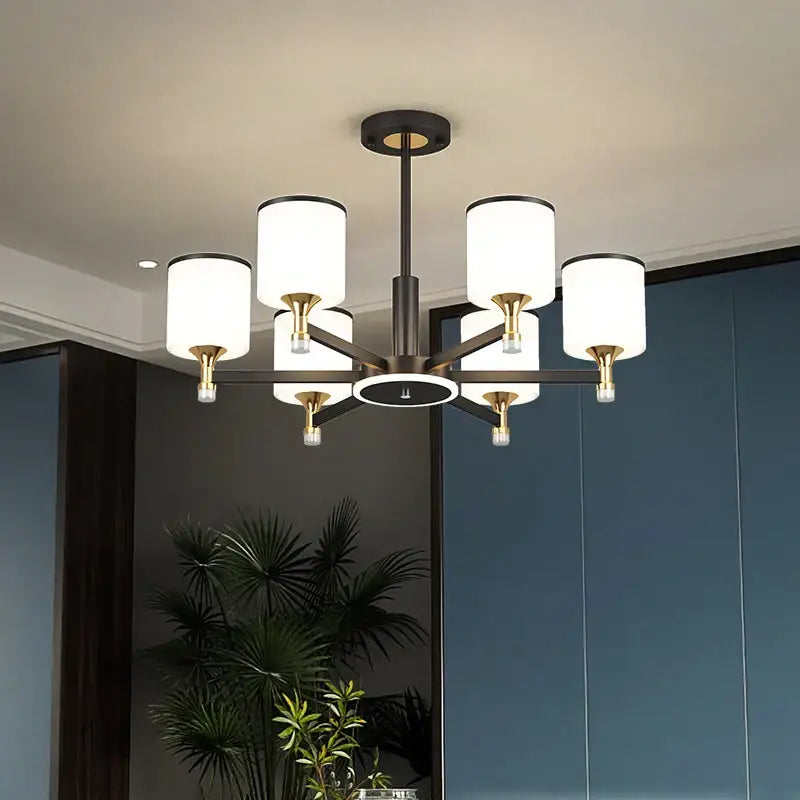 Modern dark bronze decorbites glass chandelier featuring six cylindrical white shades for living room lighting