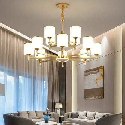 Modern dark bronze decorbites glass chandelier with gold-toned cylindrical shades and geometric design for living room light