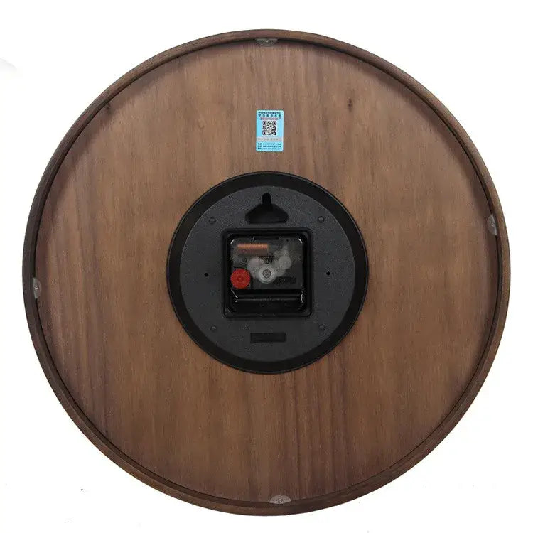 Modern dark brown bamboo wall clock with wood grain finish and black circular backing showing mechanical movement