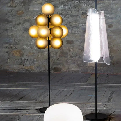 Modern dark brown bubbleglass led floor lamp with a golden spherical globe and sleek black stand for living room decorbites floor lamp