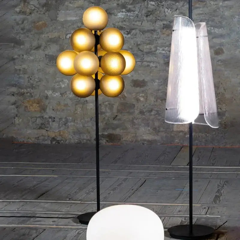 Modern dark brown bubbleglass led floor lamp with a golden spherical globe and sleek black stand for living room decorbites floor lamp