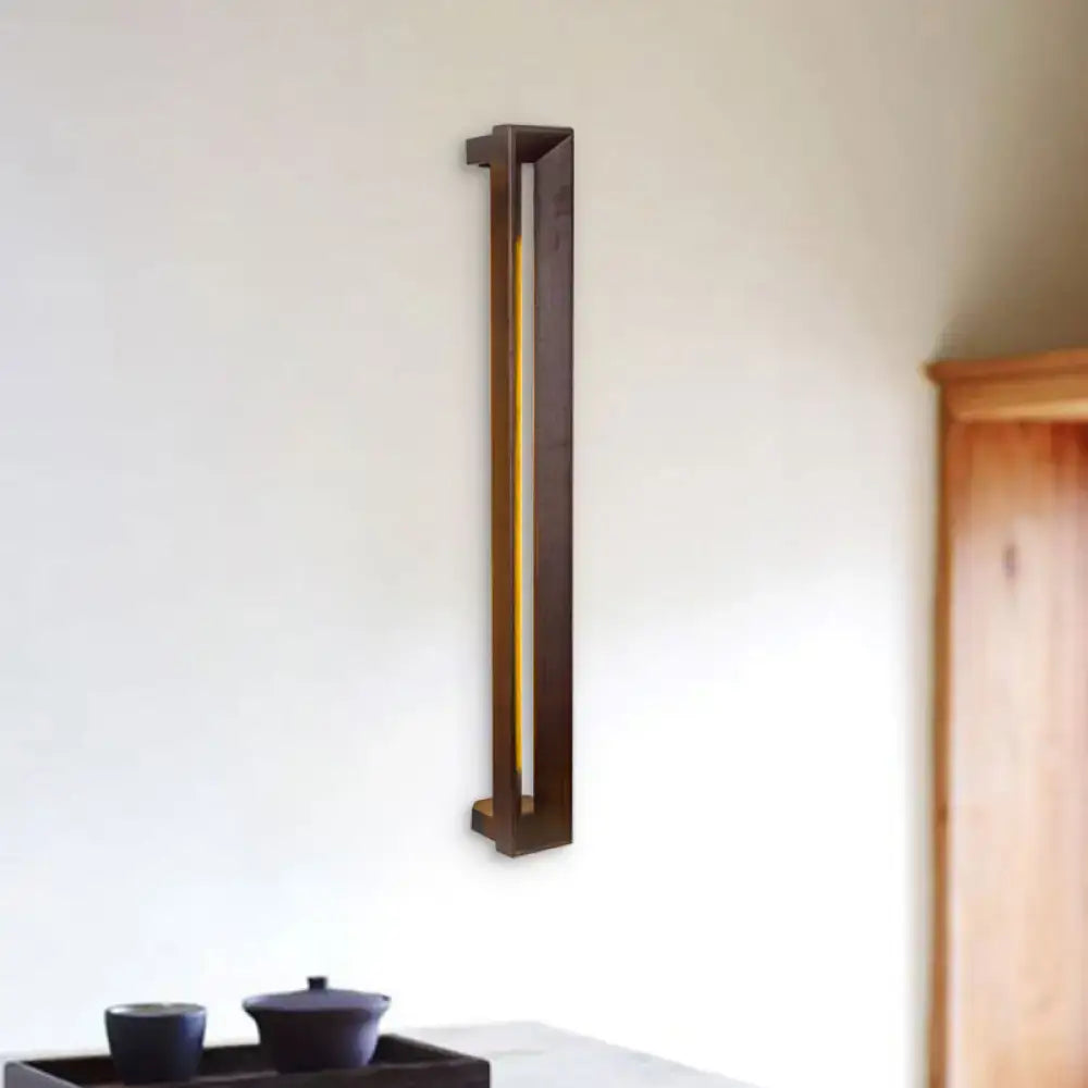 A sleek modern wooden led wall sconce with dark bronze finish and vertical gold accent for study room lighting
