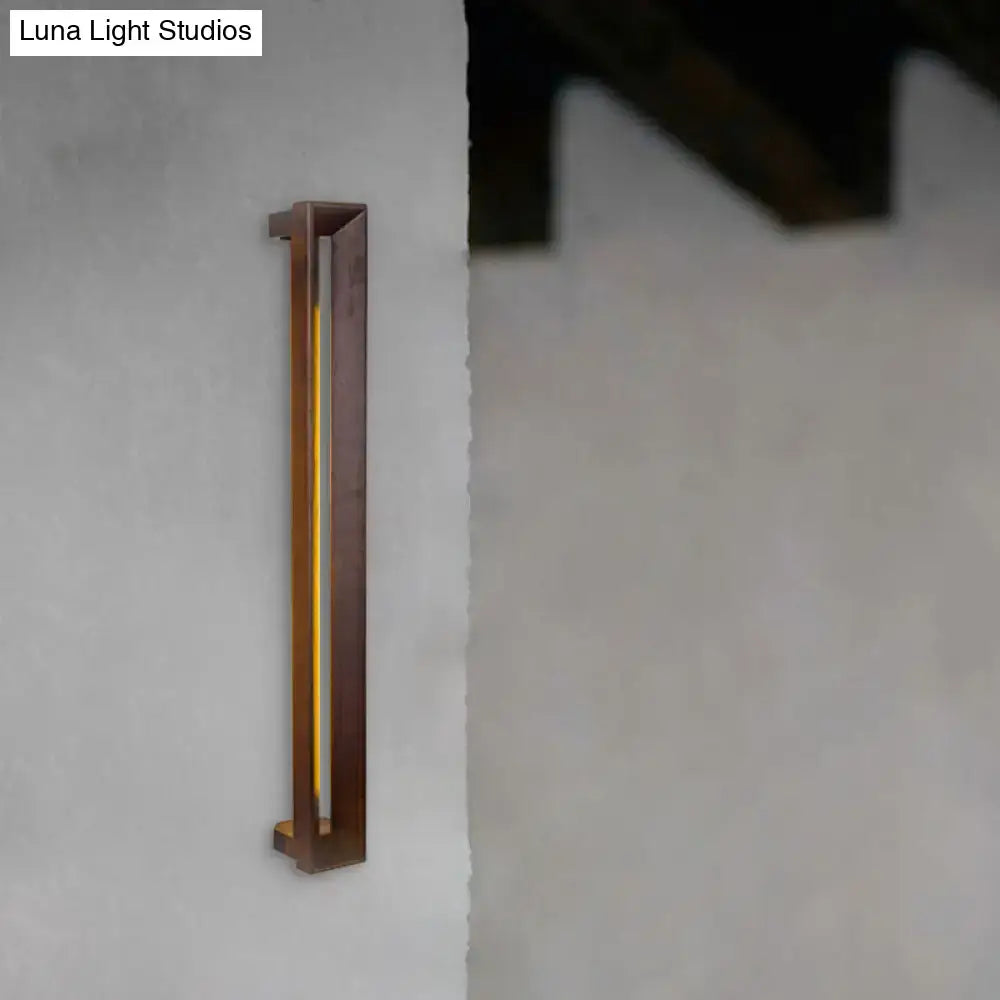A modern dark brown wooden led wall sconce with a sleek frame and warm yellow vertical illumination for study rooms
