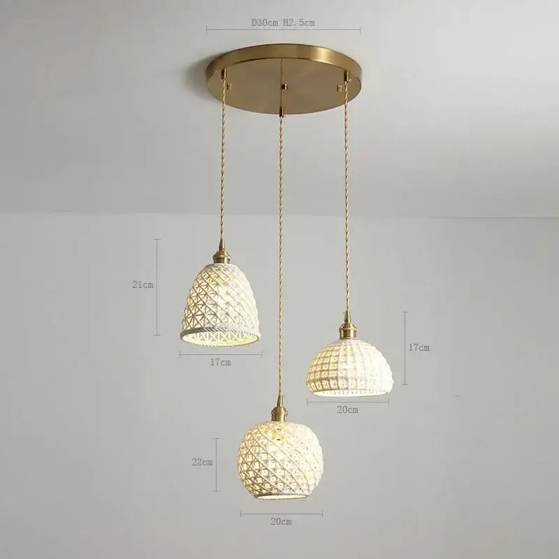 Set of three elegant brass-finished ceramic led pendant lamps with white woven glass shades for modern bedroom lighting