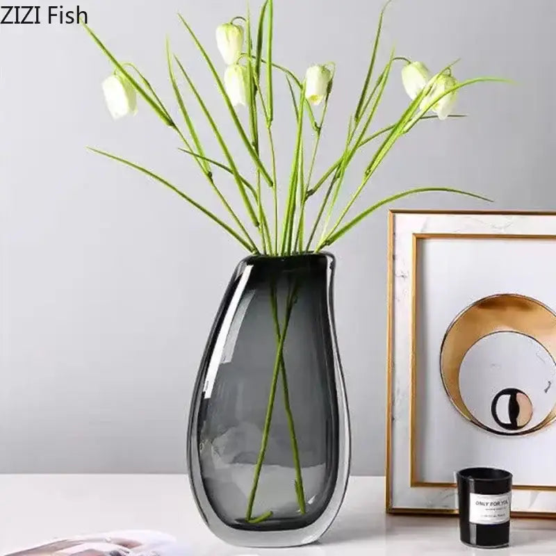A sleek dark gray double glass vase with a modern teardrop shape and reflective surface for hydroponic desk decor