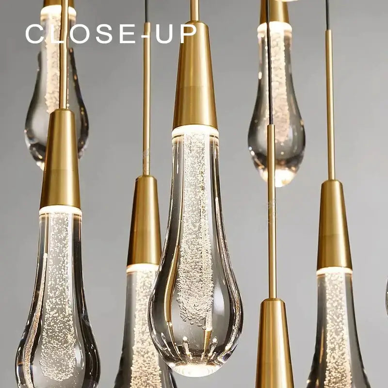 Gold-toned decorbites crystal water-drop ceiling chandelier with clear glass teardrop shades for dining room decor