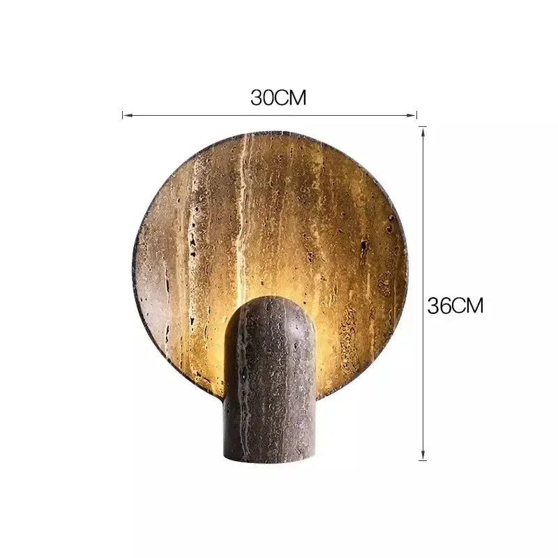 Modern wall-mounted lamp with circular textured gold-toned stone backplate and dark travertine rock cylindrical base