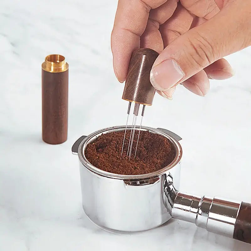 Modern dark wood espresso coffee stirrer with metal tines needle distributor pressing ground coffee in portafilter