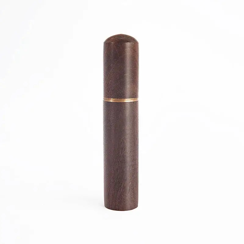Modern dark wood espresso coffee stirrer with subtle grain texture and gold band serving as a kitchen needle distributor