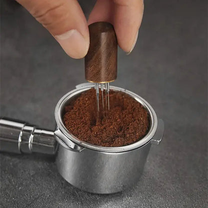 Modern dark wood espresso coffee stirrer with metallic needle distributor base for evenly compressing ground coffee