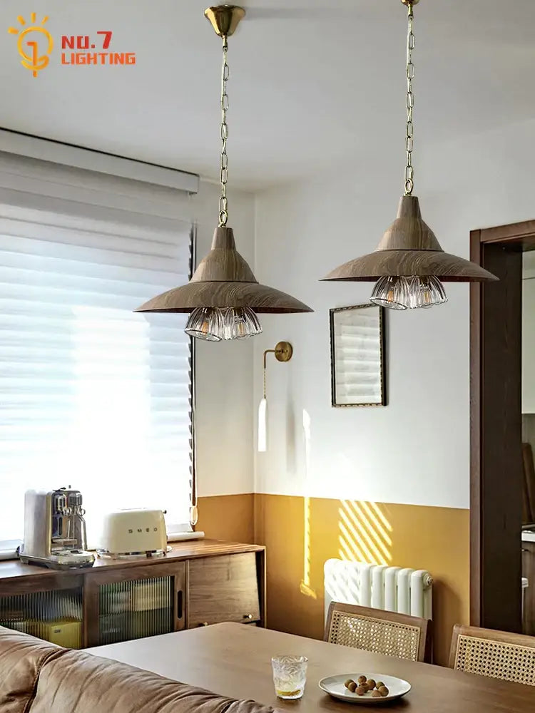 Two brass-finished pendant lights with wooden conical shades and exposed bulbs for modern dining room decorbites iron art decor