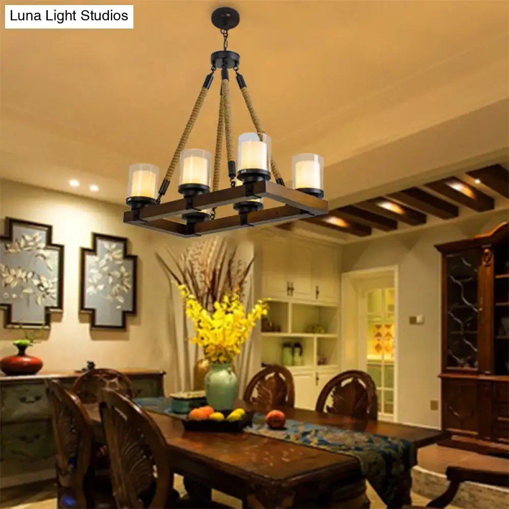 Modern dark wood island chandelier with white glass shade featuring dark metal frame and rope cords for dining room