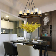 Modern dark wood island chandelier with six white glass shades emitting warm light for dining room use