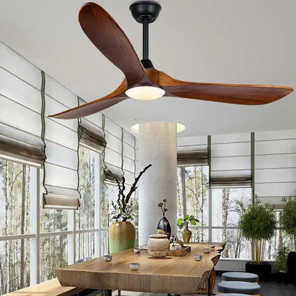 A sleek modern ceiling fan with large dark wood blades and black hub featuring remote control for living room use