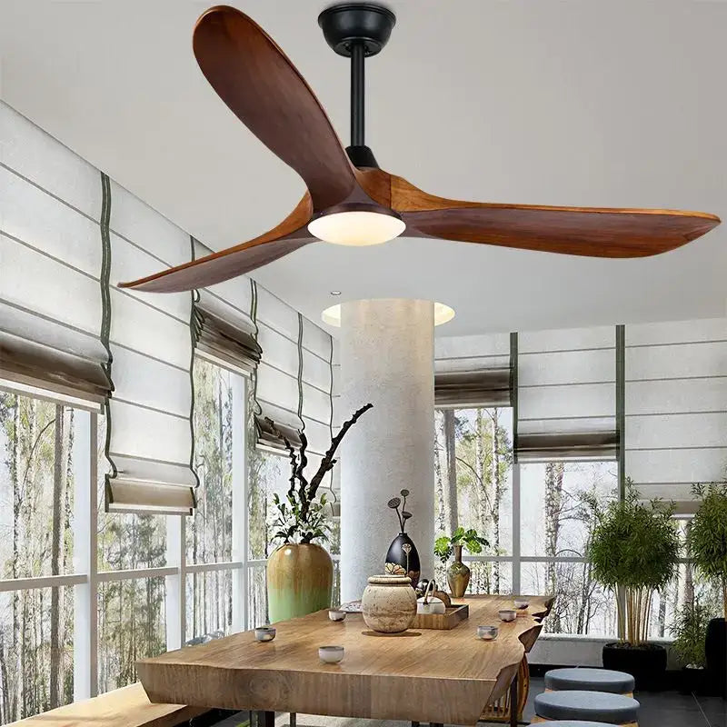 A sleek modern ceiling fan with large dark wood blades and black hub featuring remote control for living room use
