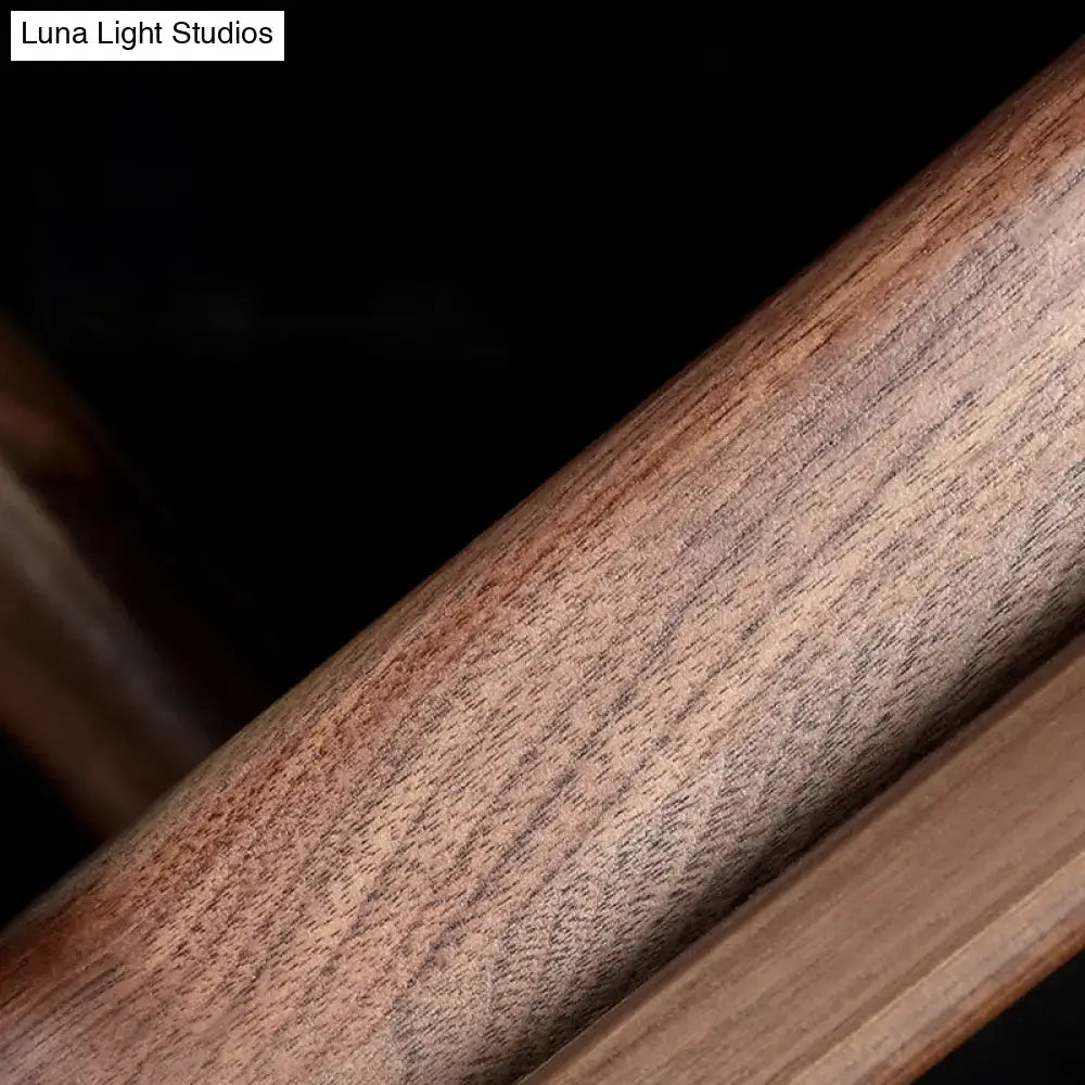 Modern dark wood linear wall sconce featuring a rich warm-toned wooden beam with smooth polished finish and natural grain patterns